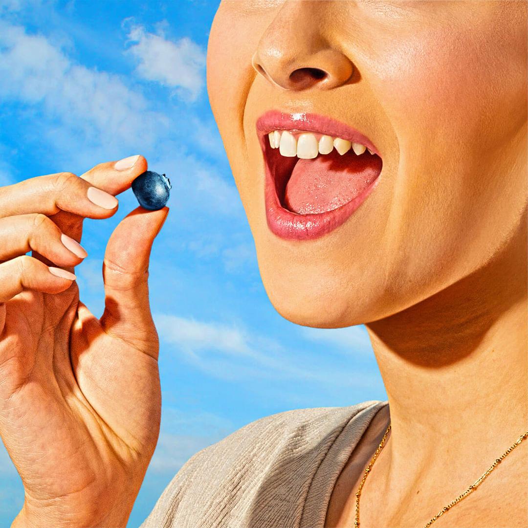 a woman eating a fruit snack